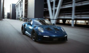 Blue sports car moving through an urban setting
