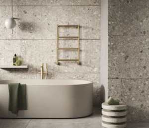 Margaroli brass towel warmer beside a freestanding bath